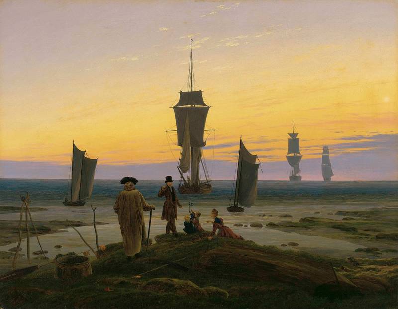 Las etapas de la vida, de Caspar David Friedrich: un anciano, un adulto, una joven y dos niños en la orilla miran barcos que navegan hacia el horizonte al atardecer.